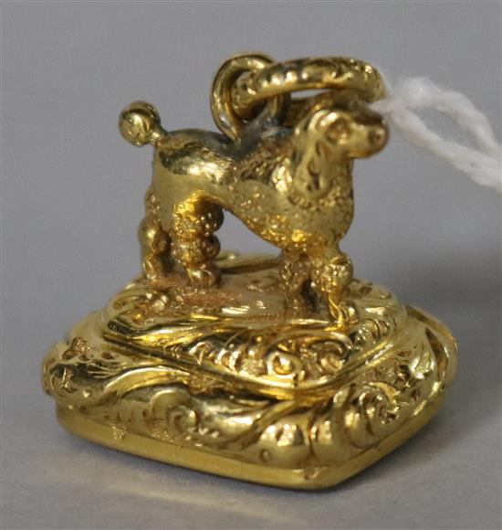 A yellow metal fob seal, with poodle mount and opaque hardstone blank matrix.